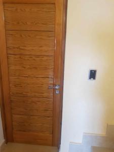 a wooden door in the corner of a room at Room Breakfast in Zarzouna