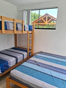 two bunk beds in a room with a window at Casa de Campo Villa Azul Cañete in Imperial +70 photos