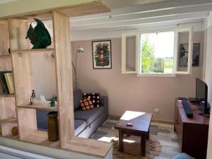 a living room with a couch and a table at Logement à castex in Castex +16 photos