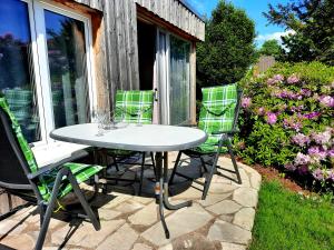 a table and chairs sitting on a patio at Ferienhaus Marie an der Weser in Bremerhaven