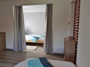 a bedroom with a door open to a bedroom with a bed at Ferienhaus Marie an der Weser in Bremerhaven