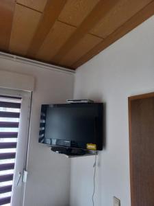 a flat screen tv on a wall in a room at 2N Appartement in Eupen