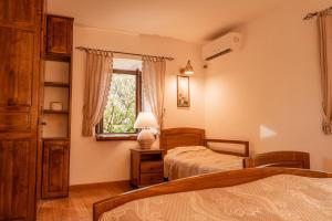 a bedroom with two beds and a window at Historic Seafront Family Villa in Rafailovici