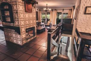 a living room with chairs and a fireplace at Sítio em São Roque, paraíso ao lado de São Paulo! in São Roque