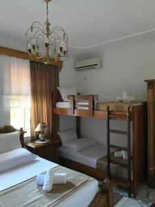 a bedroom with two bunk beds and a chandelier at Yuri Guest House in Gjirokastër