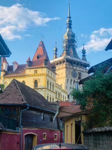 a large building with a clock tower on top of it at Pensiune Citadela Sighisoara in Sighişoara