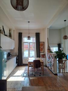 a kitchen with a table in the middle of a room at Charming house in Ghent in Ghent