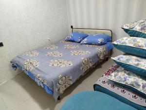 a bedroom with a bed and two pillows at Quba ALFA-M Motel in Quba