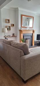 a couch in a living room with a fireplace at Holywood Town House in Town Centre in Holywood