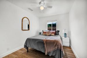 a bedroom with a bed and a ceiling fan at Retro Cottage, Hot Tub, Putting Green, walk to all in Thousand Oaks