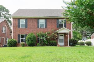 a red brick house with a green lawn at Kinston Getaway #1 in Kinston