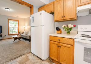 a kitchen with a white refrigerator and a living room at Kinston Getaway #1 in Kinston