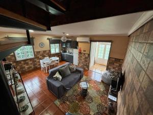 a living room with a couch and a table at Casa da Vista- Eirinha in Furnas