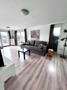 a living room with a couch and a table at Vakantiehuis Fenna in Terherne