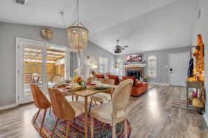 a dining room and living room with a table and chairs at Boho Indian Oasis: 3bd - Pool - Tranquil Retreat in Tallahassee