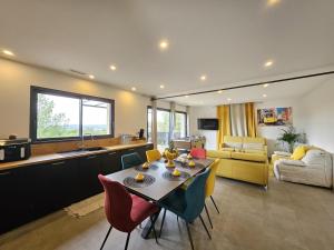 a kitchen and living room with a table and chairs at Villa lavandin in Apt