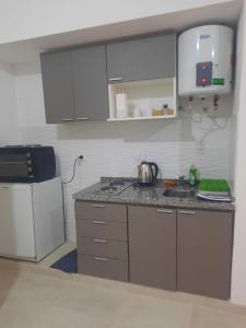 a kitchen with a counter and a tea kettle at Tu Refugio 3 - Monoambiente/Loft cerca del parque in Santiago del Estero