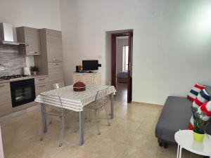 a kitchen and dining room with a table and chairs at Venere in Bari +15 photos