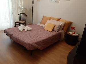 a bed with two stuffed animals on top of it at Da Federico in Trieste