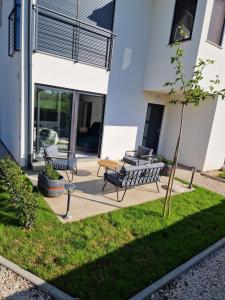 a patio with two benches and a table at Apartmani Relaxsea in Privlaka