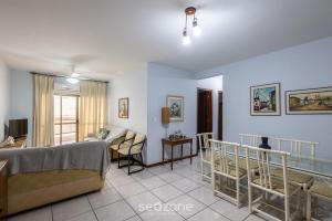 a living room with a bed and a couch at Apto c/ varanda - beira mar a Meia Praia CEO0104 in Meia Praia