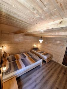 a room with two beds in a sauna at Cabana Miska Chalet in Miercurea-Ciuc