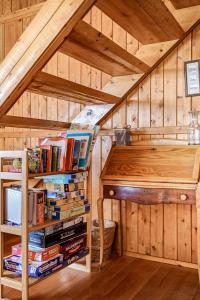 a attic room with a book shelf and a desk with books at Omena Point Paradise Waterfront Sunrise in Suttons Bay