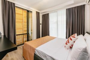 a hotel room with a bed and a large window at Ella Suites Hotel in Antalya +56 photos