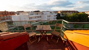 a balcony with two chairs and a table on a roof at Apartamento Somo Vistamar in Somo