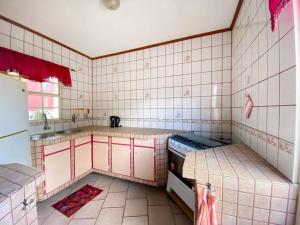 uma cozinha com paredes e balcões em tons de rosa e branco em Fayalobie Centrally Located 2 BR Guesthouse em Willemstad