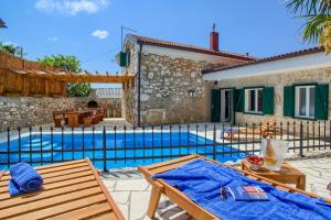 a villa with a swimming pool in front of a house at Villa Kirica in Bribir +53 photos
