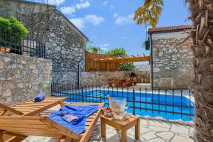 a patio with a table and a swimming pool at Villa Kirica in Bribir