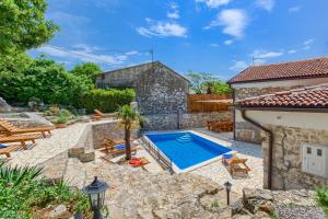 a backyard with a swimming pool and a house at Villa Kirica in Bribir
