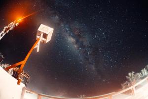 a street light with the milky way in the sky at Fasdheythere Inn Maldives in Kendhoo