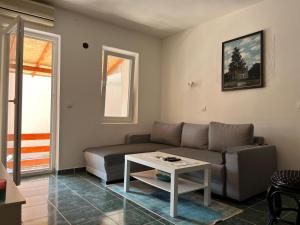 a living room with a couch and a table at GRAMISI apartments in Kruče