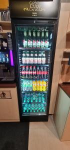 a refrigerator filled with lots of bottles of soda at Elite Pension in Štúrovo