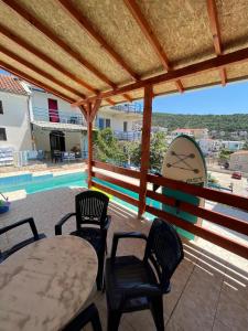 a patio with a table and chairs and a pool at GRAMISI apartments in Kruče