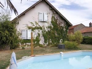 a house with a swimming pool in front of a house at Casa Di fiore in Maubourguet