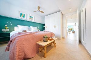 a bedroom with a large bed and a table at Amapola Palms - recién reformado, frente al mar in San Agustin