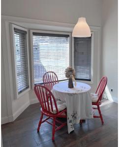 a dining room with a table and chairs and windows at Calgary-Banff single house close LRT&UC&Free Parking in Calgary