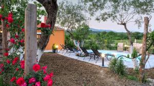 a view of a pool with chairs and flowers at Country House in Kanakádes