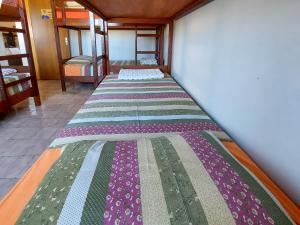 a row of beds in a room at Hostel Pajeú in Triunfo