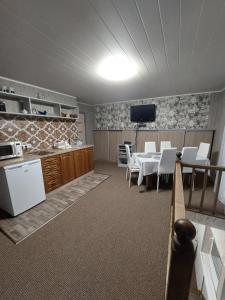 a kitchen and dining room with a table and chairs at Dariaus ir Gireno 7 in Zarasai