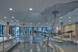 a large swimming pool in a large building at Apartmán PalacKY in Kyjov