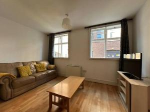 a living room with a couch and a table at City Centre Duplex Apartment in Liverpool