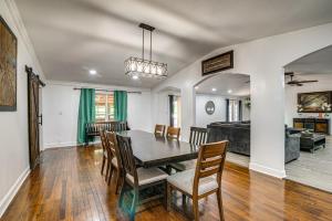 a dining room and living room with a table and chairs at Spacious Bowling Green Home with Hot Tub and Pool! in Bowling Green