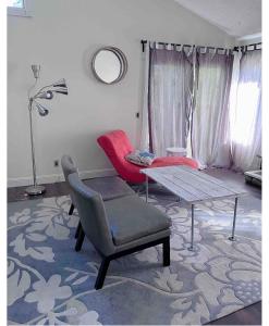 a living room with a table and a chair at Calgary-Banff single house close LRT&UC&Free Parking in Calgary