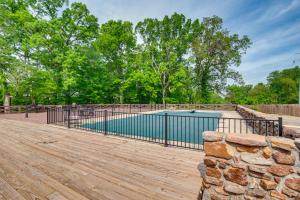 a swimming pool with a fence on a wooden deck at Spacious Bowling Green Home with Hot Tub and Pool! in Bowling Green