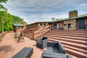 a large deck with chairs and a building at Spacious Bowling Green Home with Hot Tub and Pool! in Bowling Green