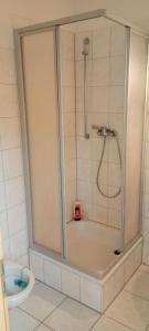 a shower stall in a bathroom with a toilet at Forrest Apartments in Freiberg Min stay 2 nights Max Number of Guest 1 Aprt 1 in Freiberg